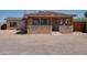 Charming single-story home featuring a stone accent wall and covered front porch at 7930 E Broadway Rd, Mesa, AZ 85208