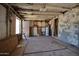 Interior view of a room with peeling paint and open studs at 7930 E Broadway Rd, Mesa, AZ 85208