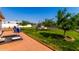 Landscaped backyard with patio, seating, mature trees, and lush lawn at 8053 E Dover St, Mesa, AZ 85207