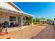 Gravel side yard features covered patio for outdoor storage and lawn beyond fence at 8053 E Dover St, Mesa, AZ 85207