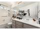 Bright bathroom with a large vanity, mirror, and shower, featuring neutral tones at 8053 E Dover St, Mesa, AZ 85207