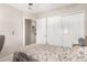 Cozy bedroom featuring a double bed, closet, and doorway at 8053 E Dover St, Mesa, AZ 85207