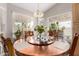 Bright dining room featuring a copper round table, natural light from multiple windows, and lovely plants at 8053 E Dover St, Mesa, AZ 85207