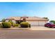 Charming single-Gathering home boasts a three-car garage, well-maintained landscaping, and a welcoming facade at 8053 E Dover St, Mesa, AZ 85207