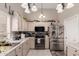 Well-lit kitchen with white cabinets, stainless steel appliances, and ample counter space at 8053 E Dover St, Mesa, AZ 85207