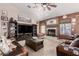 Cozy living room with fireplace, ceiling fan, and plush seating perfect for relaxation at 8053 E Dover St, Mesa, AZ 85207