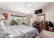 Bright main bedroom featuring a ceiling fan, carpeted floors, and bay window with seating at 8053 E Dover St, Mesa, AZ 85207