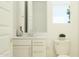 Well-lit bathroom featuring a vanity with modern fixtures, a toilet, and a window for natural light at 8323 E Petunia Ave, Mesa, AZ 85212