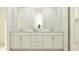 This bathroom features double sinks, vanity space, and modern decor, as well as bright, neutral colors at 8323 E Petunia Ave, Mesa, AZ 85212