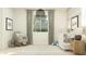 This bright Bedroom features a rocking chair, crib, and modern decor at 8323 E Petunia Ave, Mesa, AZ 85212