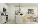 Well-lit kitchen featuring white cabinets, stainless steel appliances, and an island with bar stool seating at 8323 E Petunia Ave, Mesa, AZ 85212