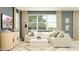 Inviting living room featuring a comfortable sectional sofa, stylish decor, and bright natural light from the windows at 8323 E Petunia Ave, Mesa, AZ 85212