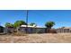 Backyard with desert landscaping, chain-link fence and a view of the home's exterior at 8527 W Jefferson St, Peoria, AZ 85345