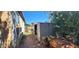Metal backyard shed surrounded by greenery and foliage with a side view at 8527 W Jefferson St, Peoria, AZ 85345