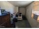 Bedroom with basic furniture, a window air conditioner and minimal decor at 8527 W Jefferson St, Peoria, AZ 85345