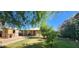 Well-kept home with lush greenery and a cozy covered porch at 8527 W Jefferson St, Peoria, AZ 85345