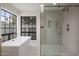 Beautiful bathroom with soaking tub and shower with glass enclosure, and brass hardware at 8648 E San Jacinto Dr, Scottsdale, AZ 85258