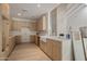 Modern kitchen with white countertops, custom wood cabinetry, and brass faucet and accessories at 8648 E San Jacinto Dr, Scottsdale, AZ 85258