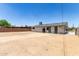 Spacious backyard with a clean, dirt landscape awaits personalized landscaping at 927 E Greenway Rd, Phoenix, AZ 85042