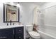 Bathroom features a stylish vanity, modern fixtures, and a shower over tub combination at 927 E Greenway Rd, Phoenix, AZ 85042