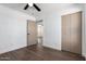 Bedroom showcases wood flooring, a ceiling fan, and a convenient closet with a neutral-toned door at 927 E Greenway Rd, Phoenix, AZ 85042