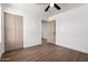Bedroom with wood flooring features a ceiling fan and closet with neutral-toned bi-fold doors at 927 E Greenway Rd, Phoenix, AZ 85042