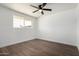 Bright bedroom with wood floors and a ceiling fan offers natural light and fresh air at 927 E Greenway Rd, Phoenix, AZ 85042