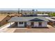 Charming single-story home with a gray roof, painted white, and desert landscaping at 927 E Greenway Rd, Phoenix, AZ 85042