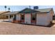 Single-story home with light-colored facade, brick accents, and low maintenance gravel landscaping at 927 E Greenway Rd, Phoenix, AZ 85042