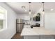 Updated kitchen with stainless appliances, an island, and stylish pendant lighting at 927 E Greenway Rd, Phoenix, AZ 85042