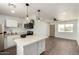 Modern kitchen features an island, stainless steel appliances, and an open layout to the living room at 927 E Greenway Rd, Phoenix, AZ 85042
