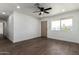 Open-concept living room features hardwood floors, a ceiling fan, and a bright, naturally lit atmosphere at 927 E Greenway Rd, Phoenix, AZ 85042