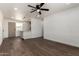 Bright living room features hardwood floors, a ceiling fan, and an open layout to the kitchen at 927 E Greenway Rd, Phoenix, AZ 85042