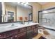 Bright bathroom features double sinks with elegant vanity and a shower-tub combination at 965 E Virgo Pl, Chandler, AZ 85249