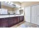 Bathroom with double sinks, granite countertops, and a large mirror over dark wood cabinets at 965 E Virgo Pl, Chandler, AZ 85249