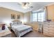 Comfortable bedroom with window, ceiling fan, carpet, and light furniture at 965 E Virgo Pl, Chandler, AZ 85249