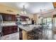 Gourmet kitchen with granite counters, stainless appliances, open layout, and backyard views to the pool and patio at 965 E Virgo Pl, Chandler, AZ 85249