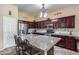 Well-appointed kitchen featuring granite countertops, stainless steel appliances, and a spacious center island with seating at 965 E Virgo Pl, Chandler, AZ 85249