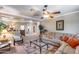 Open-concept living room is bright with a large sofa, ceiling fan, and lots of light from many windows at 965 E Virgo Pl, Chandler, AZ 85249