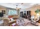 Cozy living room with large sectional sofa, decorative rug, and lots of natural light at 965 E Virgo Pl, Chandler, AZ 85249