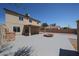 Spacious backyard featuring a covered patio and a fire pit at 10002 N 66Th Ln, Glendale, AZ 85302