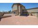 The backyard shows a gravel yard space with a covered patio and retaining wall at 10002 N 66Th Ln, Glendale, AZ 85302
