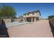 Large backyard featuring a covered patio, built-in barbecue, and low-maintenance desert landscaping at 10002 N 66Th Ln, Glendale, AZ 85302