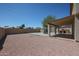 Spacious backyard featuring a covered patio with built in barbeque area and desert landscaping at 10002 N 66Th Ln, Glendale, AZ 85302