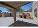Backyard featuring a fireplace and covered patio at 10002 N 66Th Ln, Glendale, AZ 85302