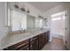 Bathroom featuring a granite countertop double vanity and shower-tub combo at 10002 N 66Th Ln, Glendale, AZ 85302
