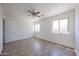 A bedroom boasting tile floors, two bright windows, and a neutral color palette at 10002 N 66Th Ln, Glendale, AZ 85302