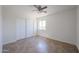 A clean bedroom with tile flooring, a window for natural light, and a closet for storage at 10002 N 66Th Ln, Glendale, AZ 85302