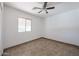 A well-lit bedroom featuring neutral tile floors and a window for natural light at 10002 N 66Th Ln, Glendale, AZ 85302