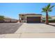 Charming home with a two-car garage, a palm tree, and low-maintenance landscaping in the front yard at 10002 N 66Th Ln, Glendale, AZ 85302